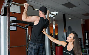Working through a lift with the trainer watching form